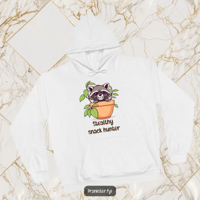 Funny raccoon in disguise peeking from behind a large potted plant, featured on a warm and cozy hoodie.