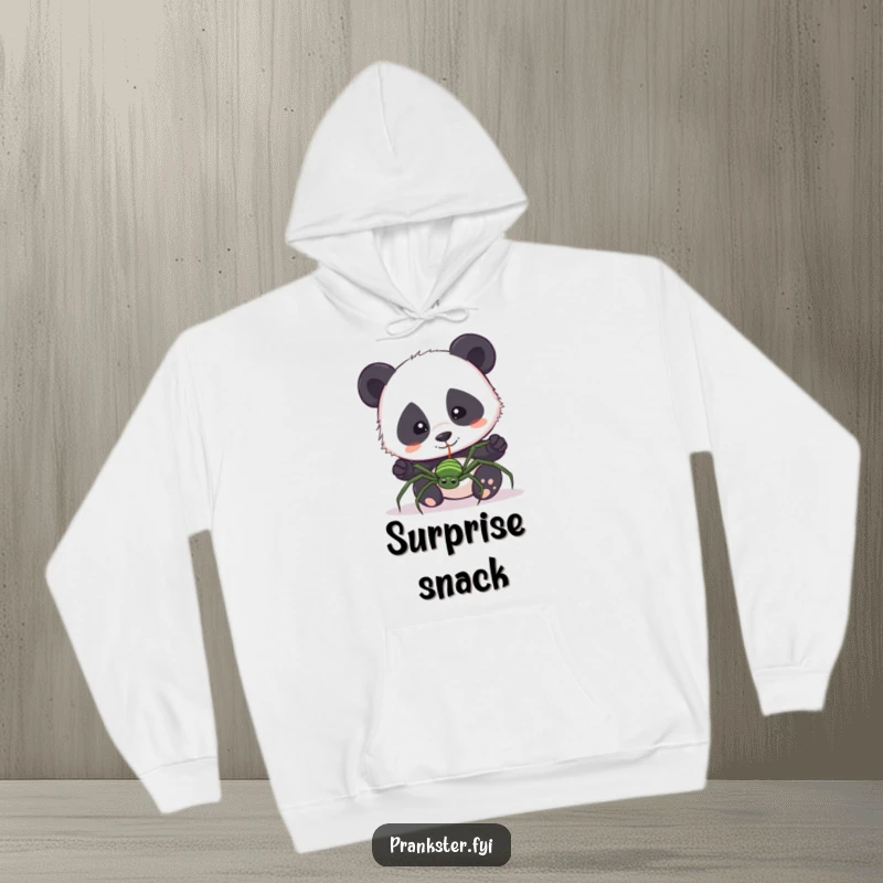 Funny hoodie with a curious panda accidentally pulling a fake spider on a string. Cozy and humorous.