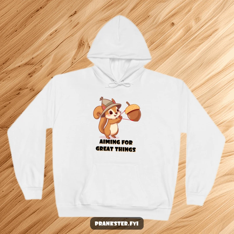 Funny squirrel acrobat hoodie, featuring a squirrel in a hat using a slingshot to launch an acorn, for humorous adventure.