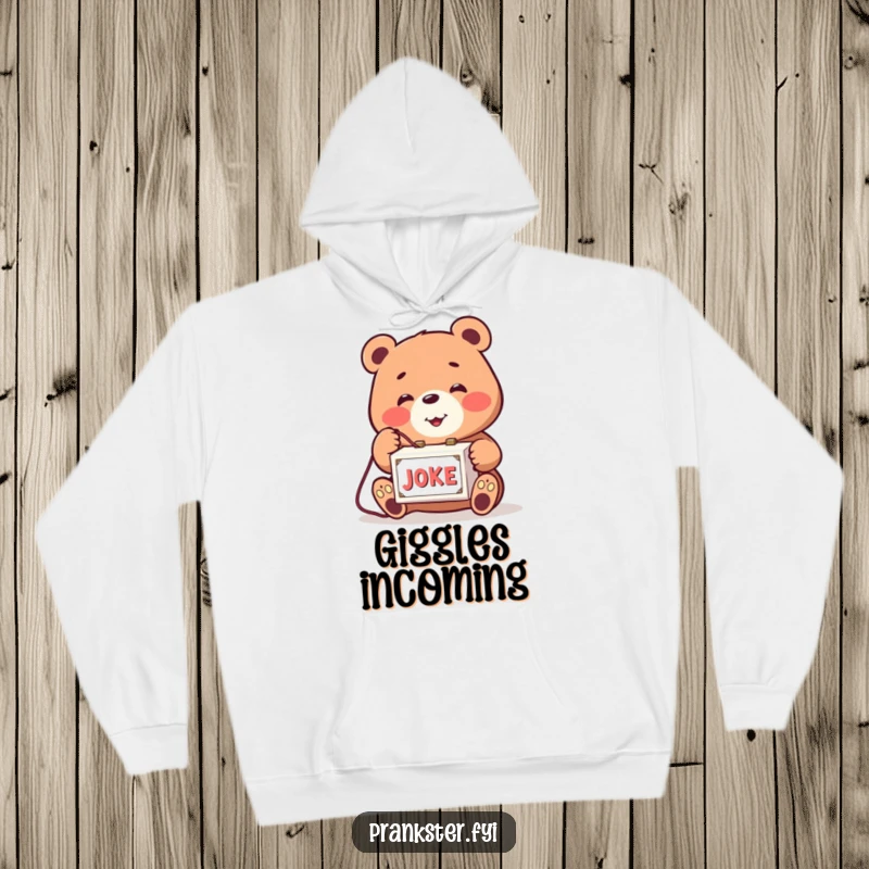 Funny hoodie with a smiling bear playfully tapping a string to a joke box. Cozy and humorous.
