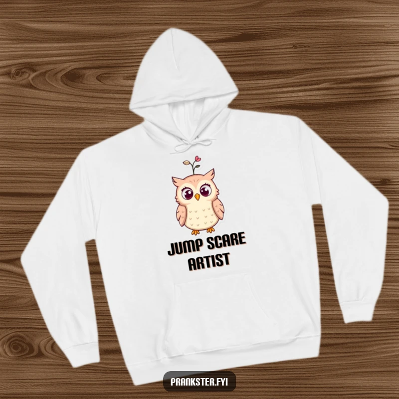 Funny hoodie depicting a startled owl, eyes wide in surprise, with a spring popping out of its hat, perfect for cozy humor.