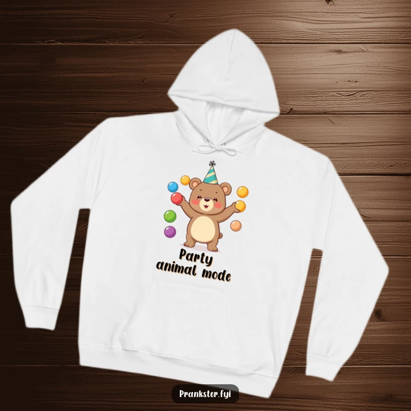 Funny bear hoodie featuring a bear in a party hat juggling colorful balls. Cozy and festive.