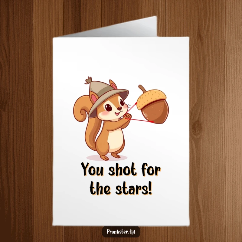 Funny free printable congratulations card showing a squirrel in a tiny hat using a slingshot to launch a large acorn, signifying a big success.